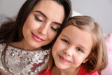 Portrait of cute little girl with mother