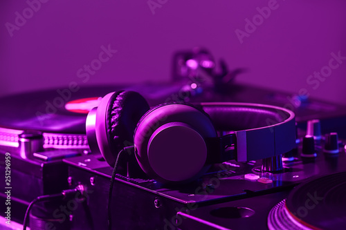 Headphones on modern DJ mix...