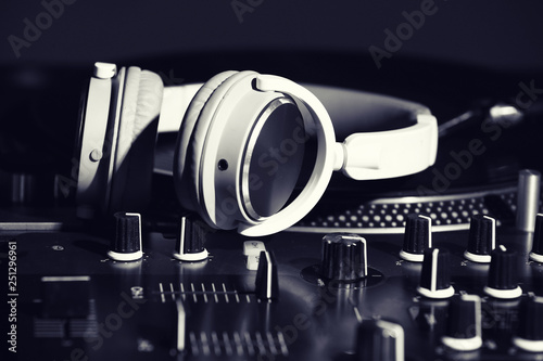 Headphones on modern DJ mix...