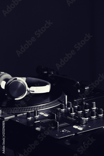 Modern DJ mixer on dark bac...