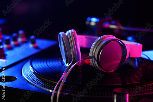 Headphones on modern DJ mix...