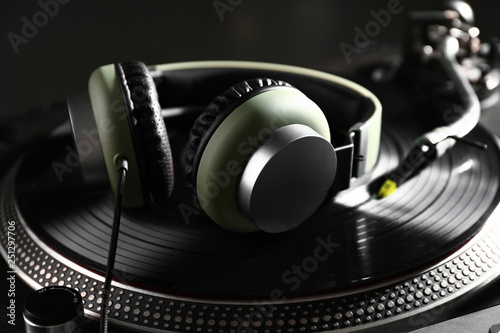 Headphones on modern DJ mix...