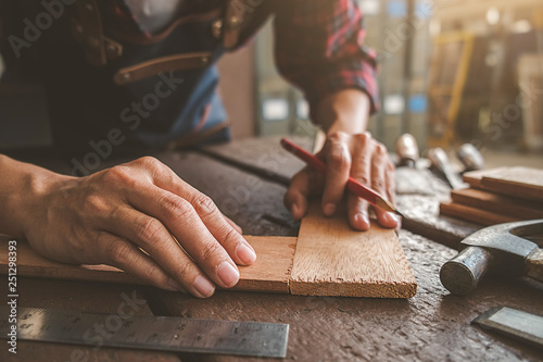 Carpenter working with equipment on wooden table in carpentry shop. woman works in a carpentry shop. photo