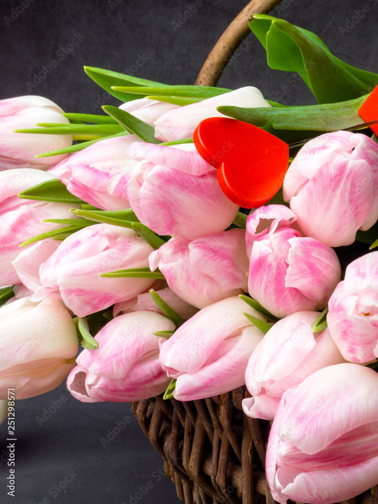 Fototapeta premium pink tulip flowers in a basket
