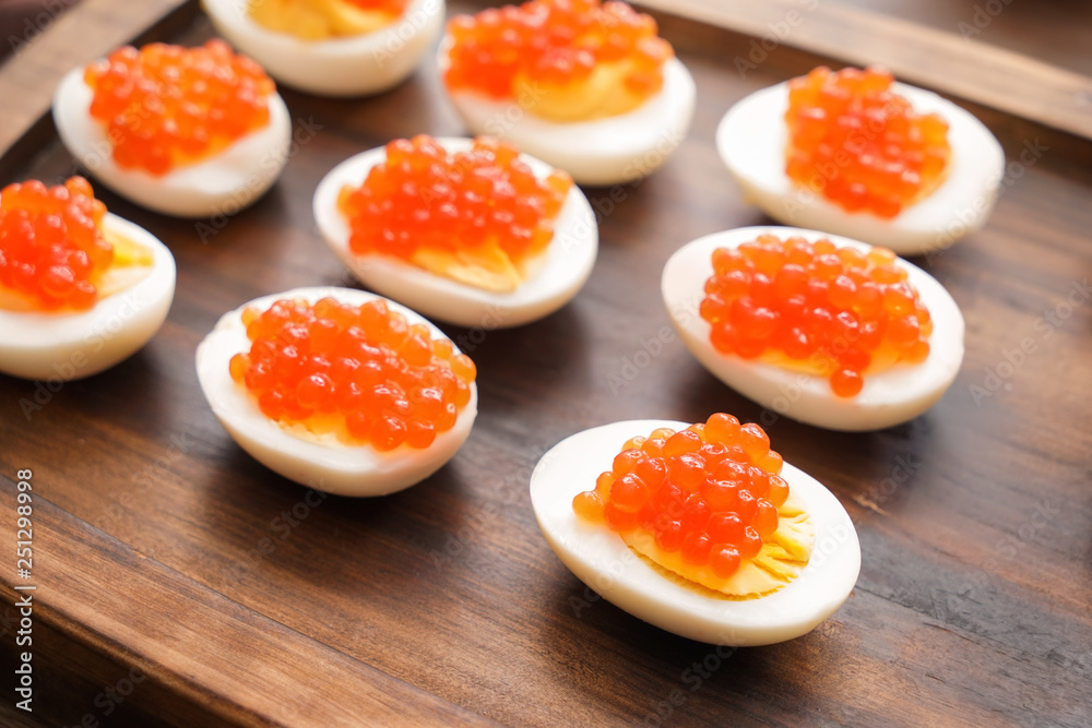 Tasty deviled eggs on wooden board, closeup Tasty deviled eggs on wooden board, closeup