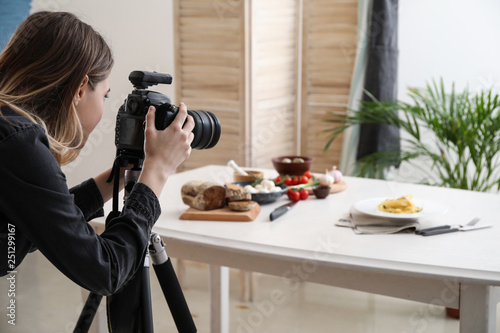 Female food photographer working in home studio