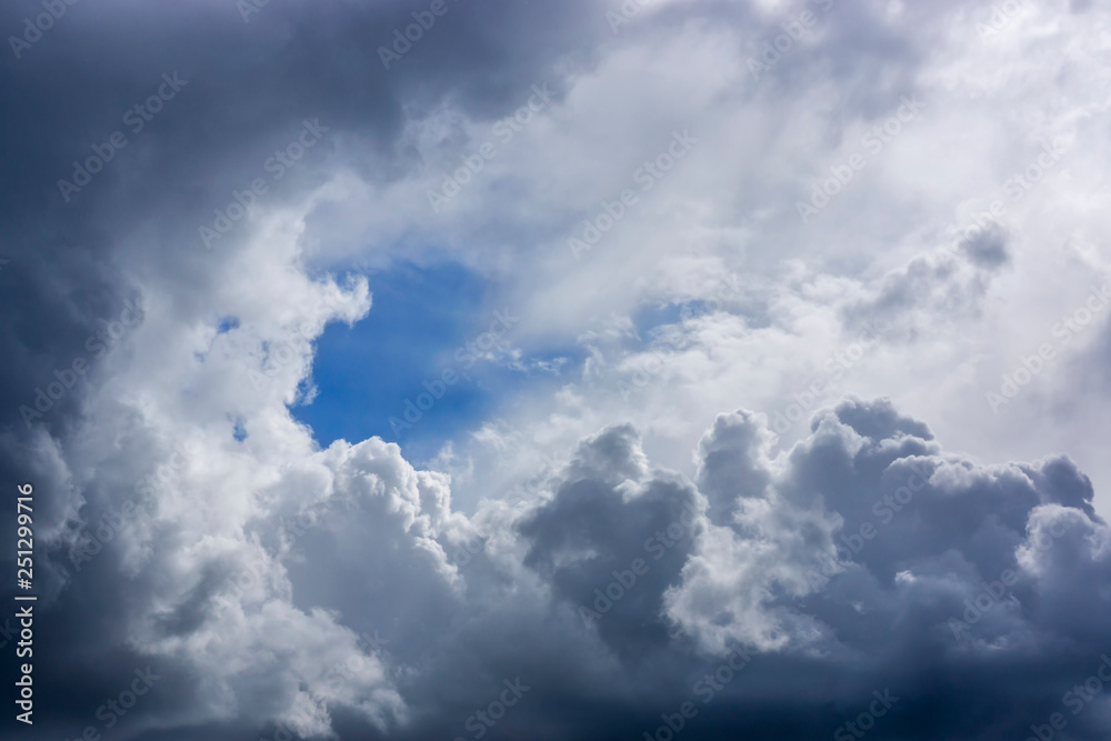 Gentle lush clouds background with gap of blue sky Gentle lush clouds background with gap of blue sky