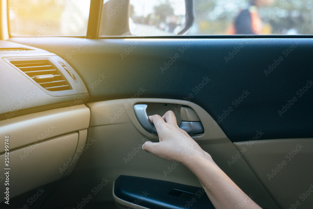 Hands open door car and  lock door control panel of auto button glass controlling window in the car