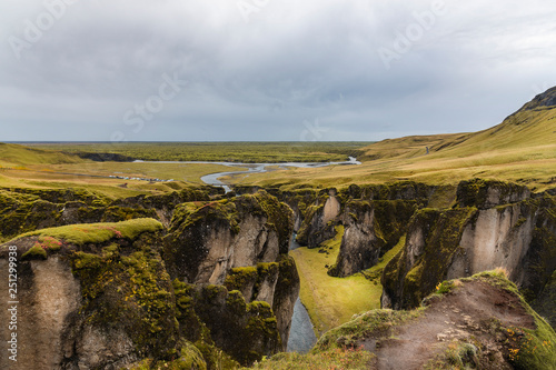 Fjadrargljufur canyon steep cliffs and waters of Fjadra river, south Iceland  photo