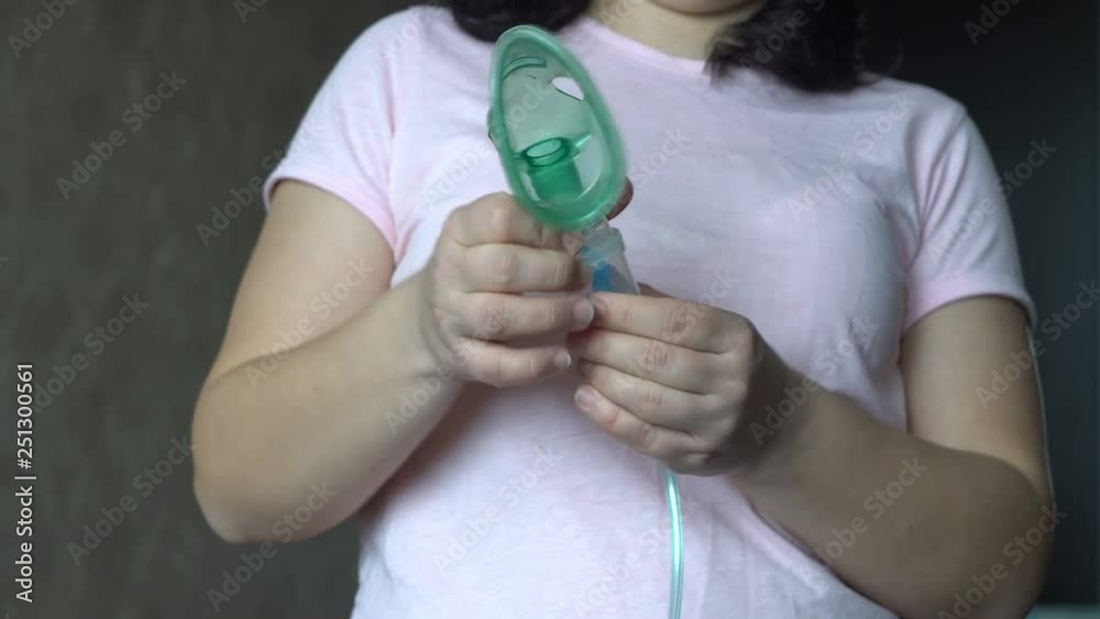 Woman collects device for inhalation. Without a face. Medical treatment. Disease. Room in the house. Human health. 4K video Woman collects device for inhalation. Without a face. Medical treatment. Disease. Room in the house. Human health. 4K video