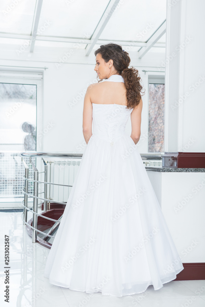 Beautiful young bride with curly hair in white wedding dress Beautiful young bride with curly hair in white wedding dress
