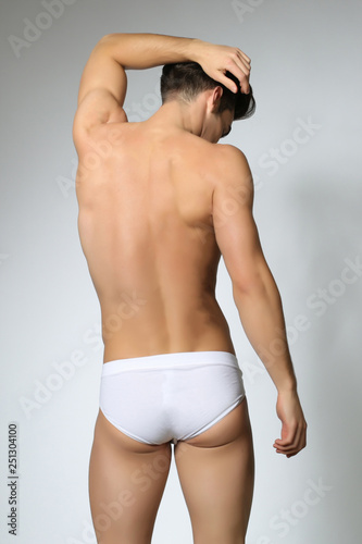 Man posing in white underwear