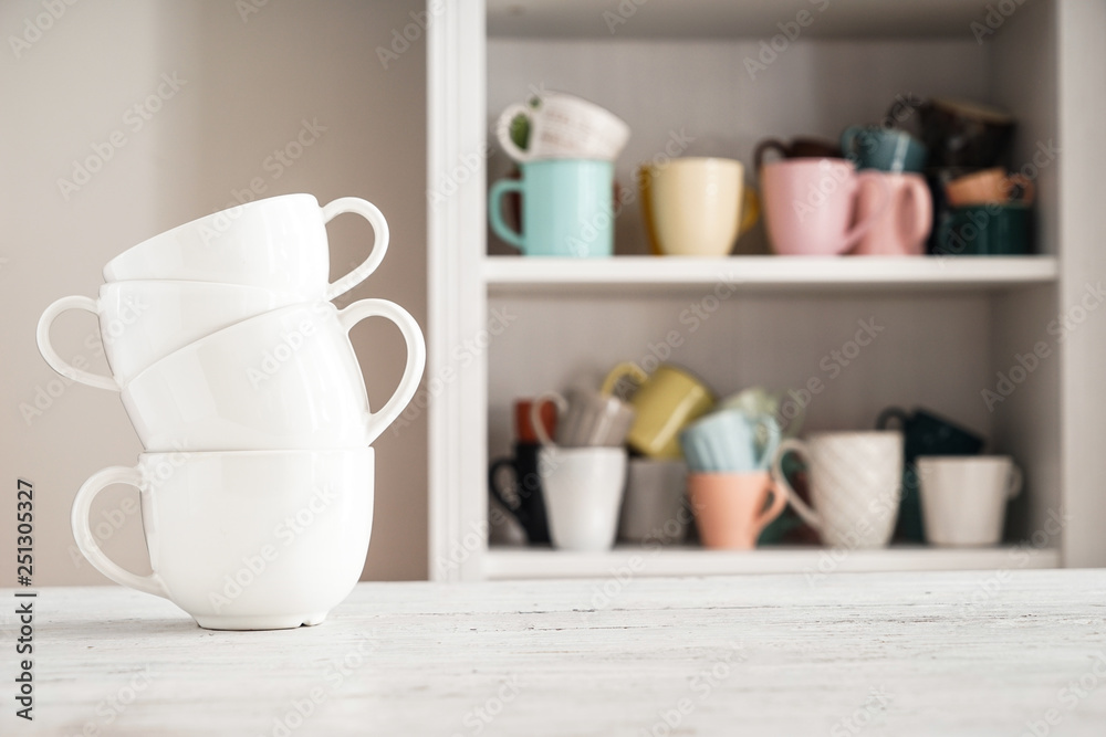 Stack of ceramic cups on white table