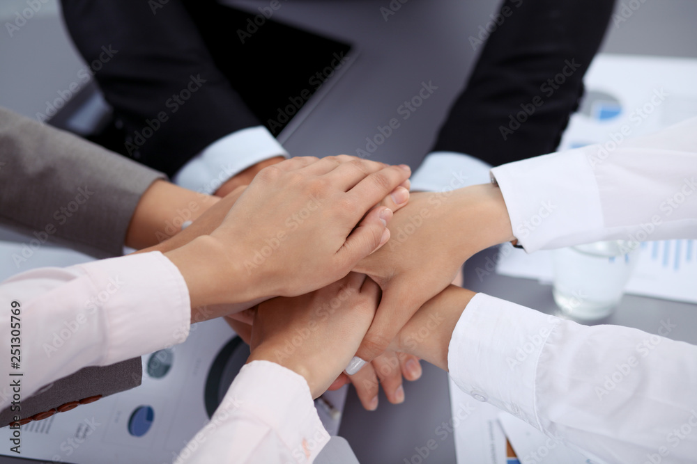 Fototapeta premium Business people group joining hands and representing concept of friendship and teamwork. Meeting of success team
