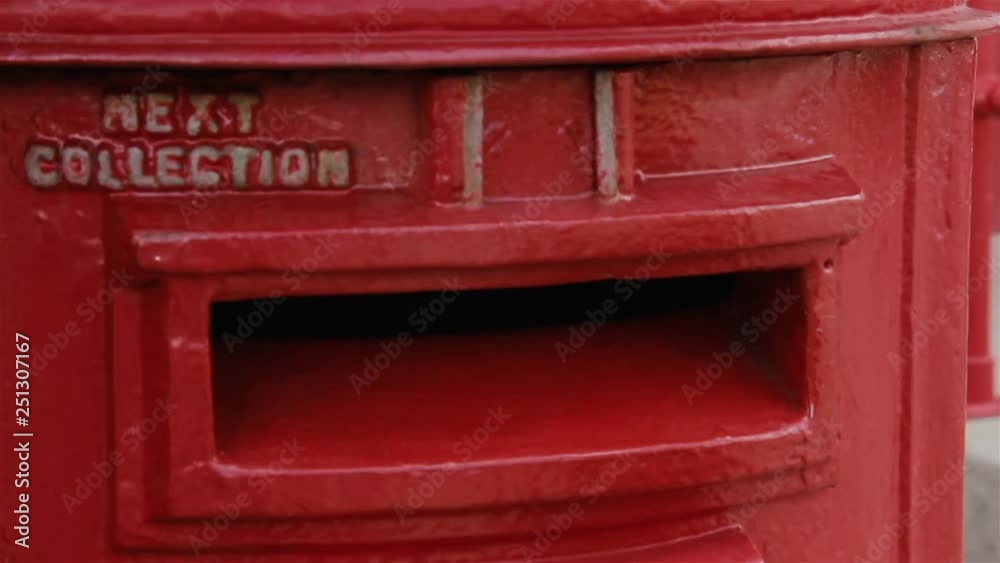 Young Boy Posting A Letter In A Traditional Red Letter Box. Young Boy Posting A Letter In A Traditional Red Letter Box.