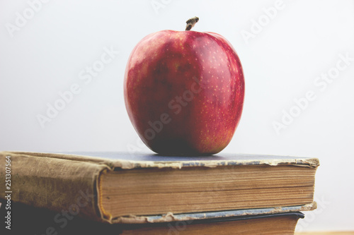 red apple and books on the table