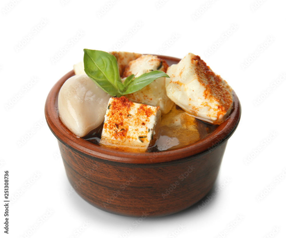 Bowl with tasty feta cheese, spices and olive oil on white background Bowl with tasty feta cheese, spices and olive oil on white background