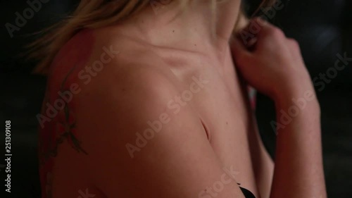 Close up of woman removes a bra from shoulder