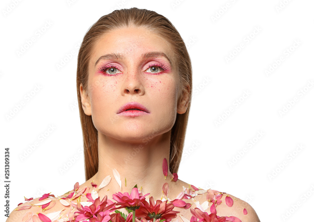 Fototapeta premium Beautiful woman with creative makeup and flowers on white background