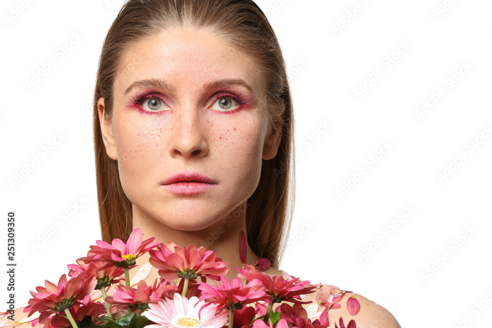 Fototapeta premium Beautiful woman with creative makeup and flowers on white background
