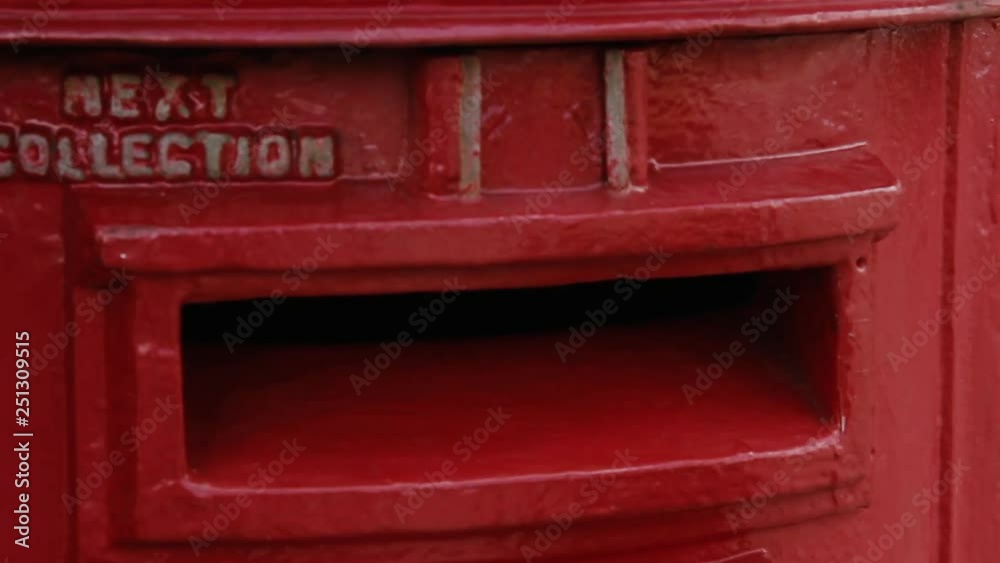 Young Boy Posting A Letter In A Traditional Red Letter Box. Zoom In. Young Boy Posting A Letter In A Traditional Red Letter Box. Zoom In.