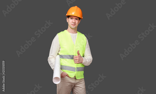 the man keeps a paper roll, gesture in a helmet - OK, everything is good