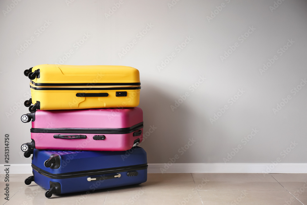 Packed suitcases near light wall Packed suitcases near light wall