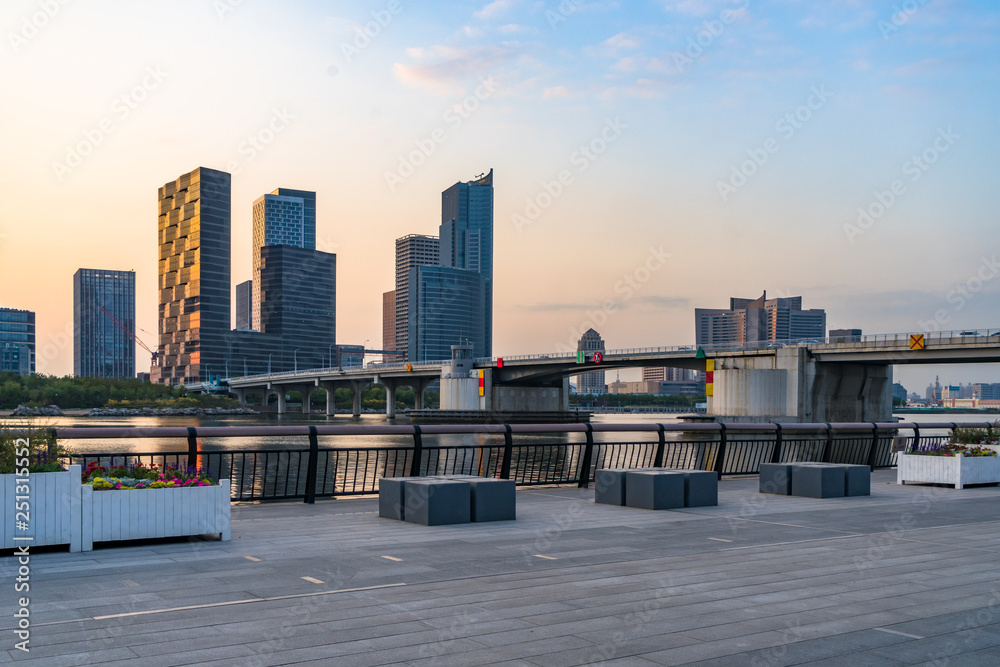 empty brick floor with cityscape and skyline at dusk empty brick floor with cityscape and skyline at dusk