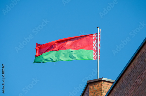 Belarusian flag against the blue sky