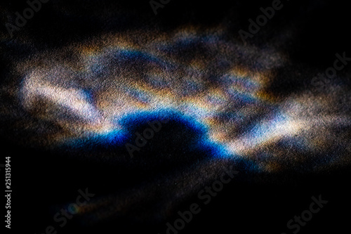 abstract light glow, lens flare, caustics water glas reflections.  light through a prism. black background. 