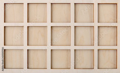 Empty square shapes  in wood plate. Laser cut squares background.