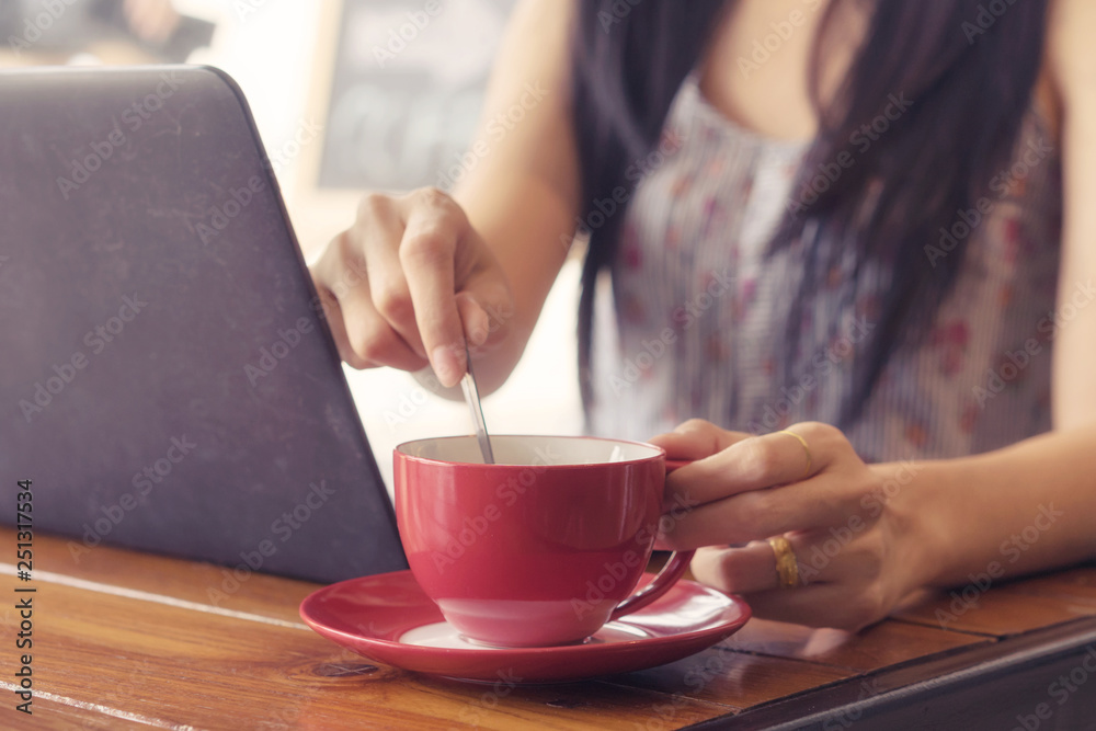 young woman drinking hot coffee in cafe and working. young woman drinking hot coffee in cafe and working.