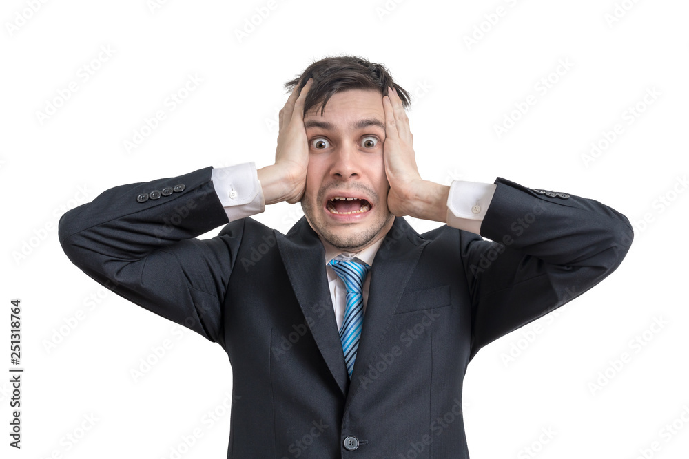 Stressed funny young businessman is holding his head. Isolated on white background. Stressed funny young businessman is holding his head. Isolated on white background.