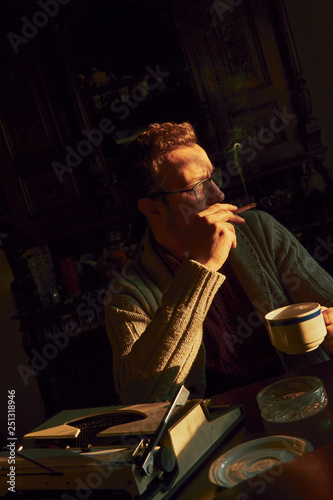 Wallpaper Mural Young man writing on old typewriter. Torontodigital.ca