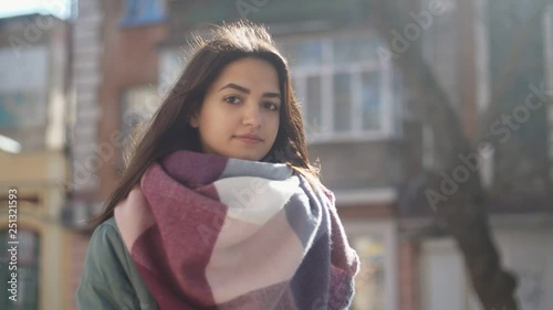 Top grade girl in a fancy scarf smartening up elegantly in street in winter in slo-mo  photo