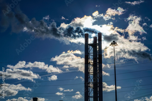 The warm air coming out of the pipes mixes with the clouds and blocks the sun. Ecological cleaning of flue gases from impurities