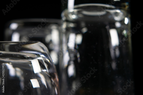 Close up of three different empty shot glasses on black background. © Vasily Merkushev
