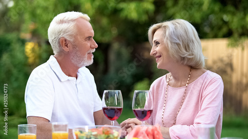Old couple celebrating anniversary  drinking wine  everlasting love relations