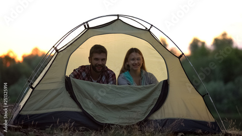Funny couple zipping dome tent, protection from insects, camping in wild