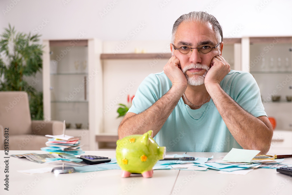 Fototapeta premium White bearded old man in budget planning concept