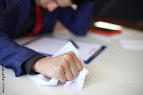 Crumpled paper in businessman hand