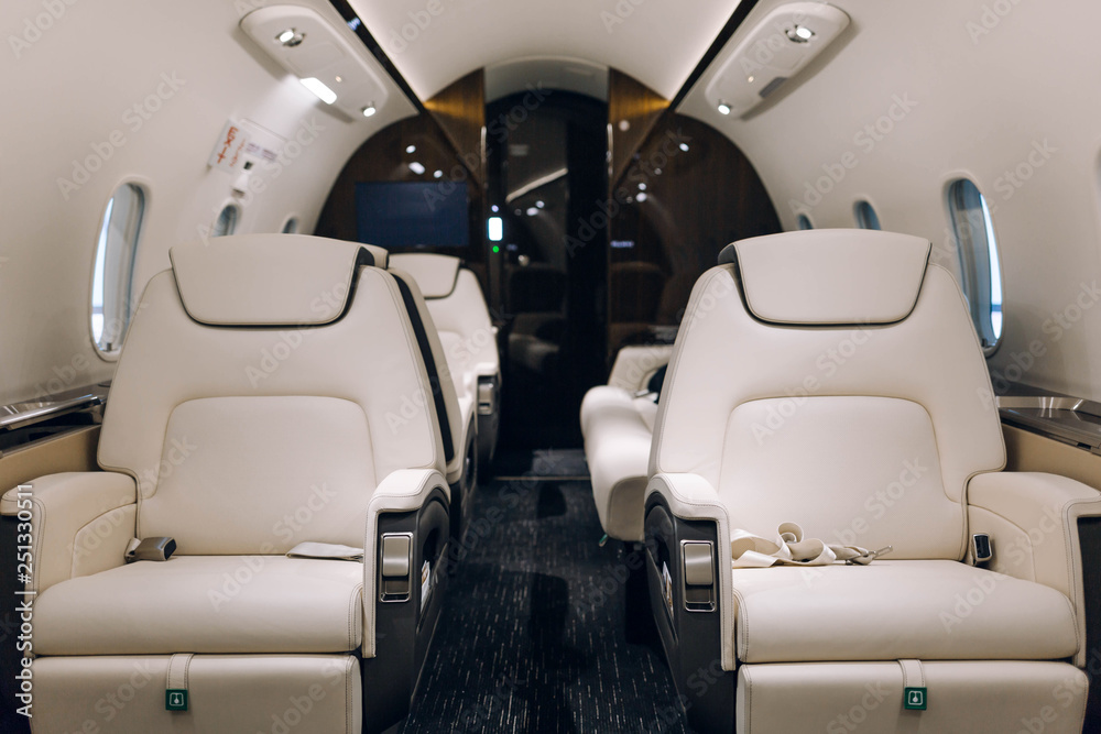 Fototapeta premium Business jet aircraft interior with comfortable leather seats