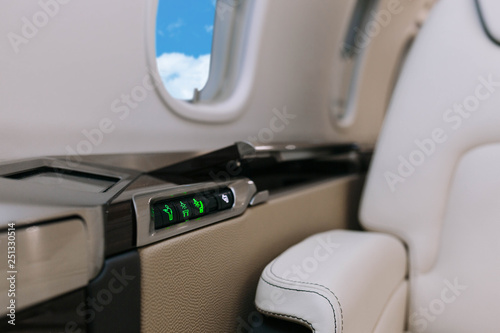 Business jet aircraft interior with leather seats with control panel