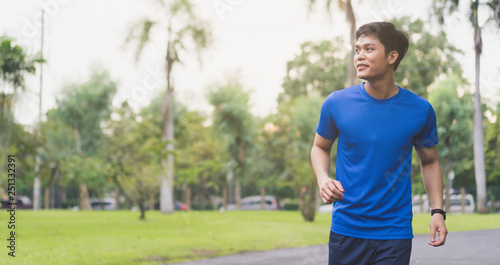  Photos Close up young asian man running at outdoor park in the morning for cardio activity concept 