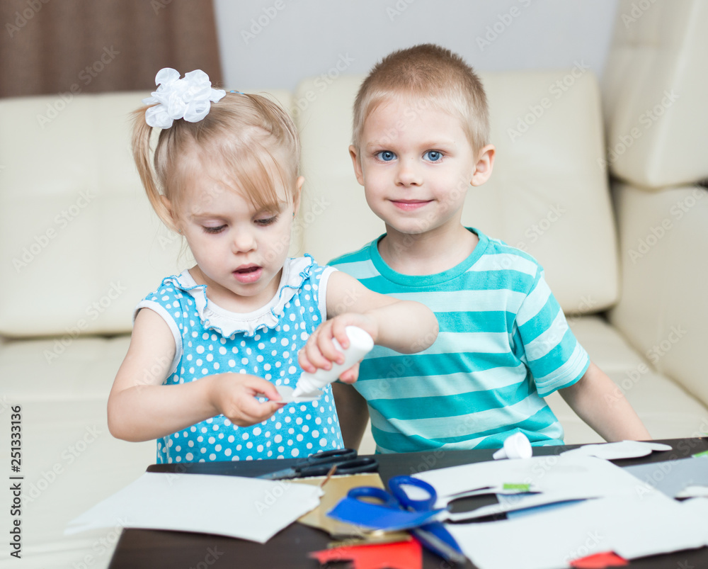 cute, smiling children, boy and girl, brother and sister 3-5 years old, scissors and cut out applications cute, smiling children, boy and girl, brother and sister 3-5 years old, scissors and cut out applications