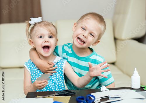 cute, smiling children, boy and girl, brother and sister 3-5 years old, scissors and cut out applications