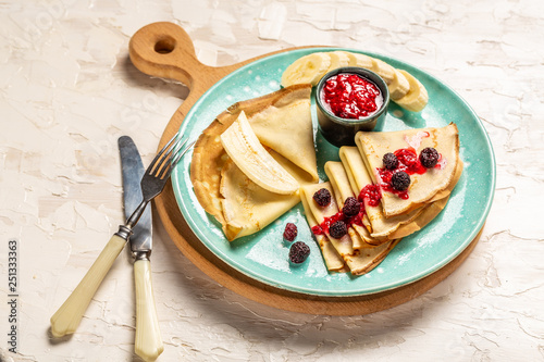 Delicious Tasty Homemade crepes or pancakes with raspberries and blueberries. Delicious homemade Crepes for breakfast photo