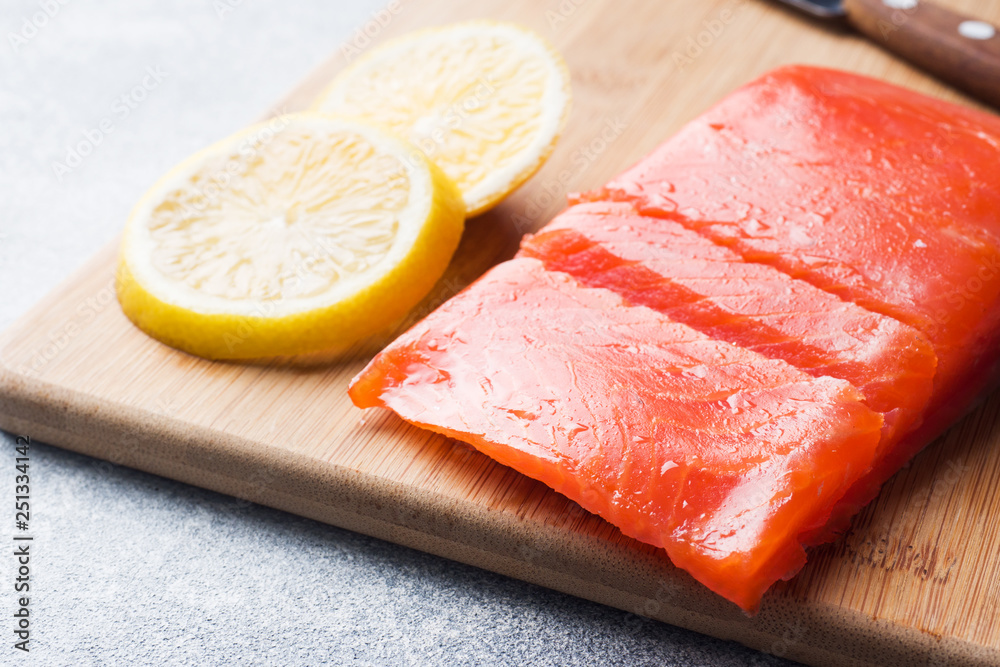 Fresh salmon fillet with lemon on a cutting Board. Fresh salmon fillet with lemon on a cutting Board.