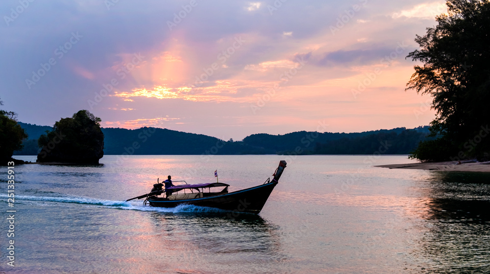 Thai traditional wooden longtail boats at the sunset in Krabi province. Thailand.