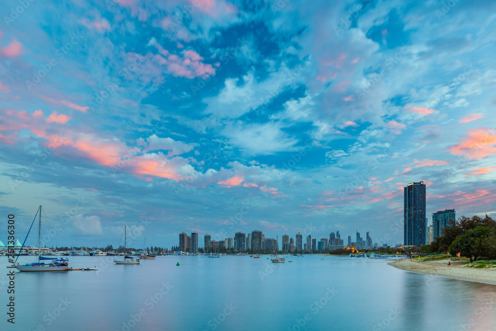 Beautiful sunset sky over moored boats and luxury real estate. Gold Coast, Queensland, Australia